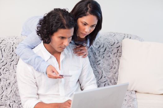 Young couple booking vacations online together