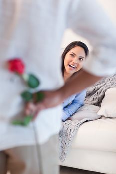 Young woman about to get a flower by her boyfriend