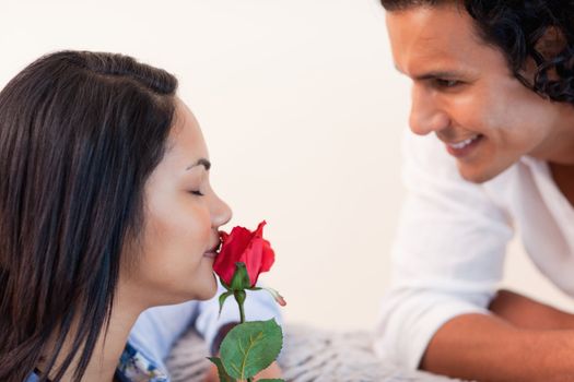 Young man giving his girlfriend a rose for valentines day