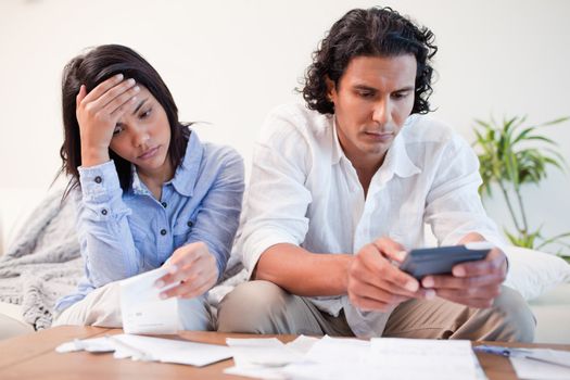 Young couple checking bills