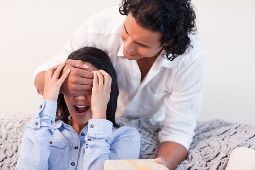 Young man giving his girlfriend a small present