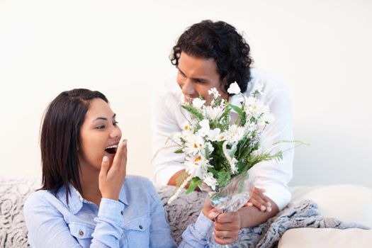 Young woman getting flowers from her boyfriend