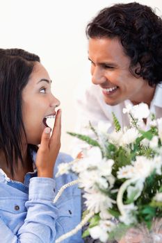 Young woman is surprised by the bouquet she got from her boyfriend