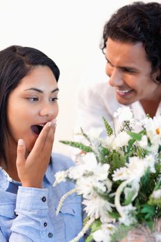 Young woman surprised by the bouquet she got from her boyfriend