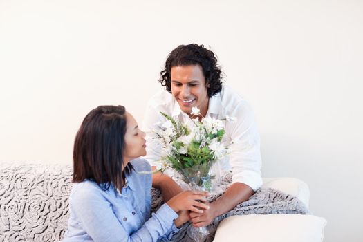 Young man giving his girlfriend flowers