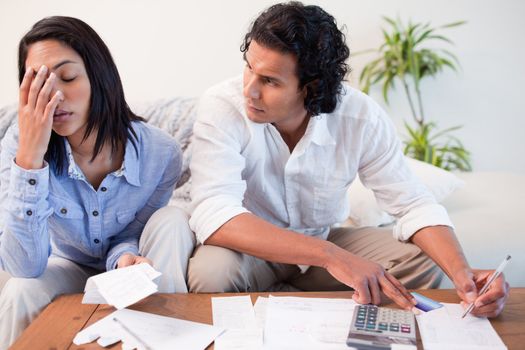 Young couple checking their bills