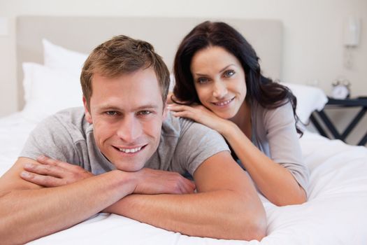 Young couple relaxing on the bed together