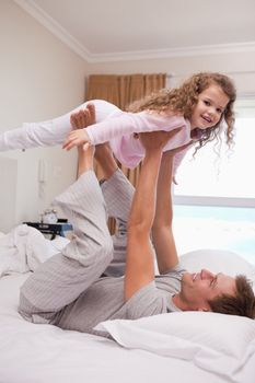 Young father letting his daughter fly