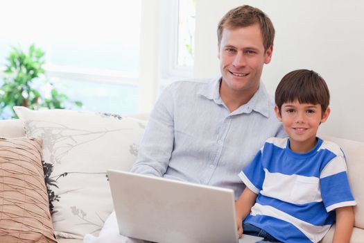 Young father and son playing computer games together