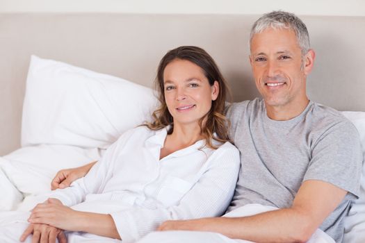 Couple lying on a bed in the morning