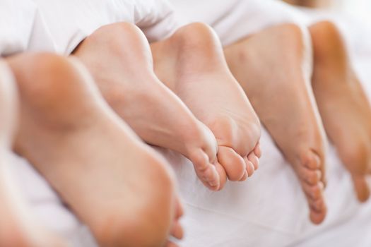 Close up of feet in a bed