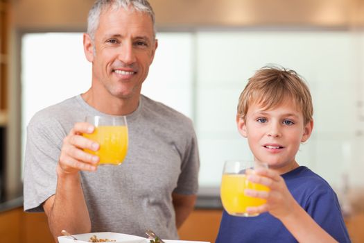Boy and his father having breakfast in a kitchen