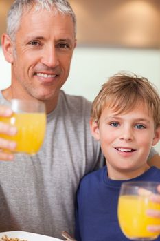 Close up of a boy and his father having breakfast in a kitchen