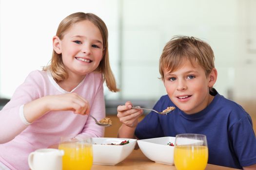 Children having breakfast in a kitchen
