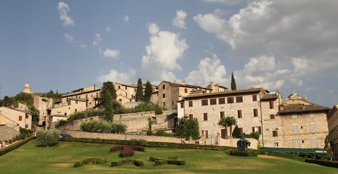 View of Assisi and a field with the word peace in latin. Assisi  was the birthplace of St. Francis, who founded the Franciscan religious order