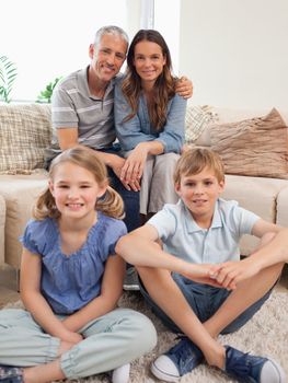 Portrait of a family posing in a living room