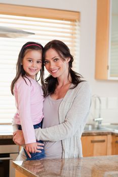 Portrait of a girl and her mother in a kitchen