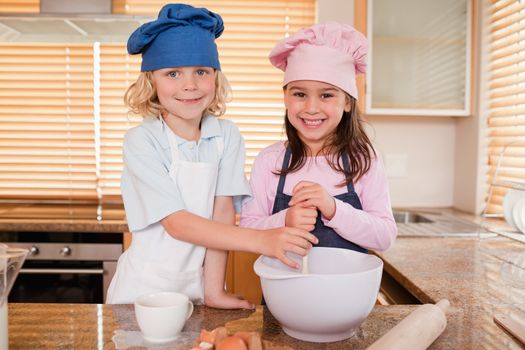 Siblings baking together in a kitchen