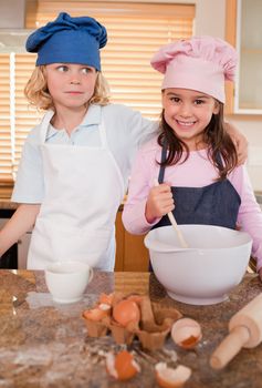 Portrait of siblings baking together in a kitchen