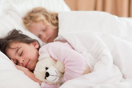 Quiet siblings sleeping in a bedroom