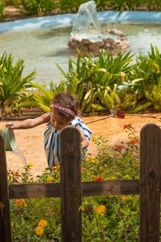 Small girl having fun playing gardening games