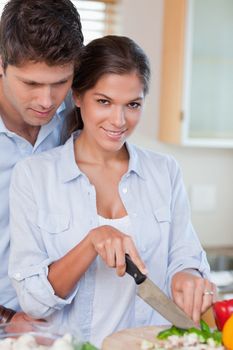 Portrait of a young couple cooking in their kitchen