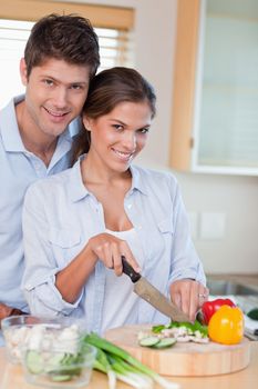 Portrait of a married couple cooking in their kitchen