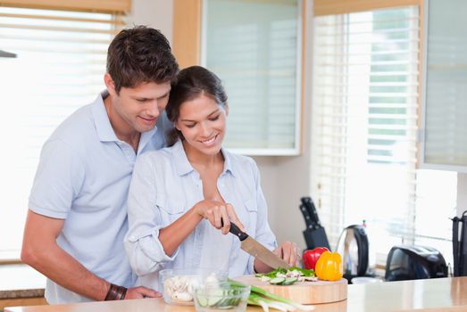 Happy couple cooking in their kitchen