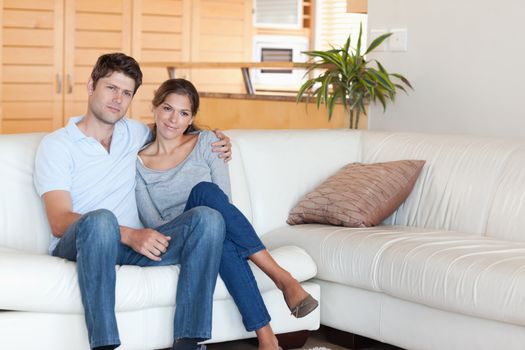 Couple sitting on a couch in their living room