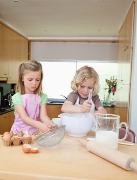 Brother and sister preparing dough together