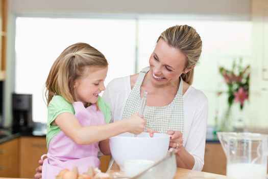 Mother and daughter having fun together in the kitchen