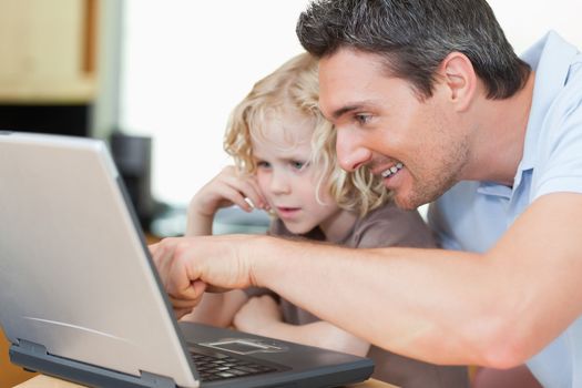 Father showing his young son the internet