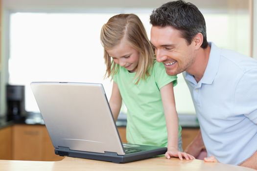 Father and daughter together with laptop