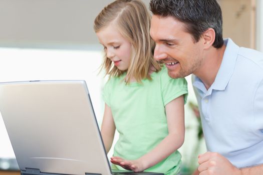 Father and daughter together with notebook