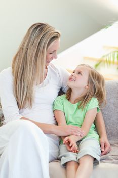 Mother and daughter sitting on the couch