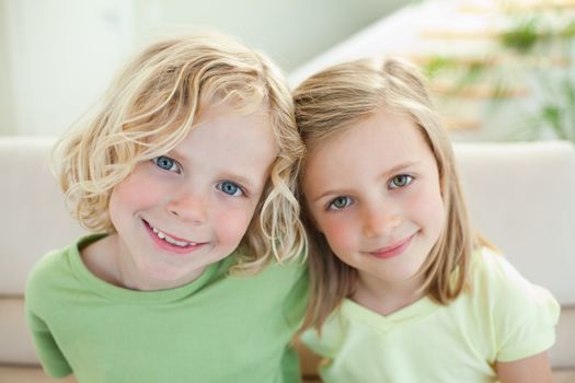 Smiling siblings together on the sofa