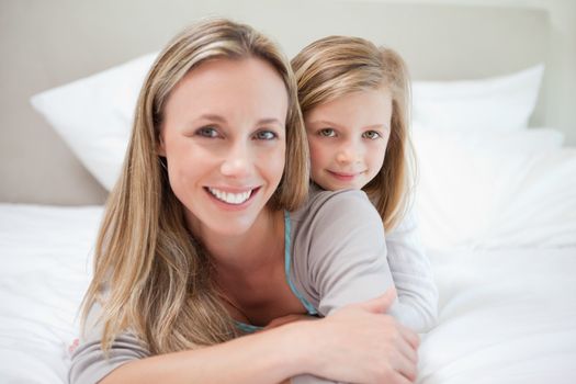 Little girl lying on her mothers back