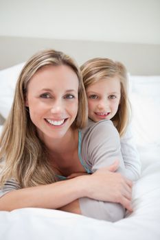 Little girl laying on her mothers back