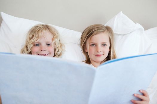 Brother and sister reading bedtime story together