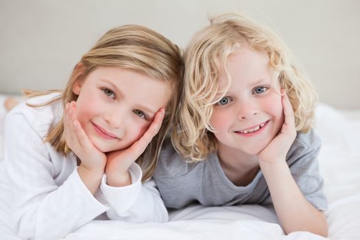 Brother and sister lying on the bed together