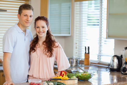 Couple standing behind kitchen counter together