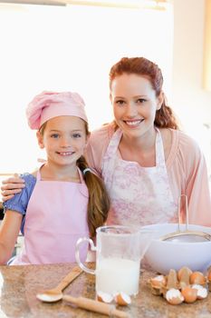 Mother and daughter preparing dough for cookies together