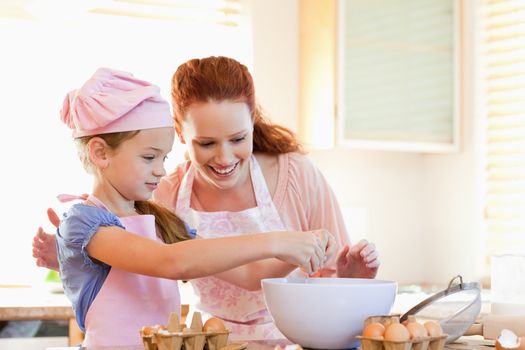 Mother and daughter preparing cookies together