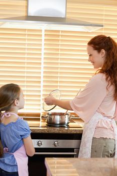 Mother and daughter preparing meal together