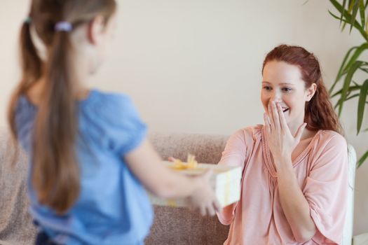 Mother being surprised by her daughter with present