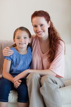 Happy mother and daughter on the couch