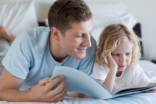 Father and son reading a magazine together