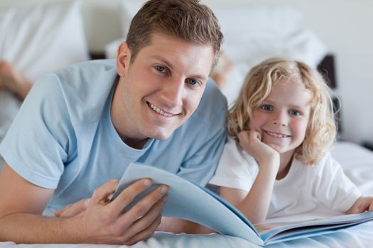 Father and son looking at magazine together