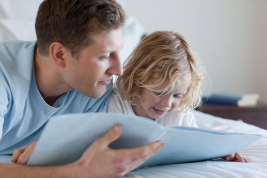 Father and son reading together