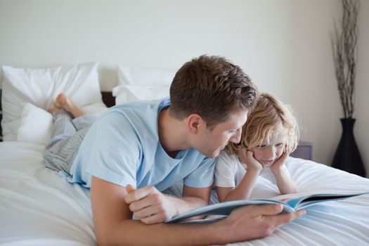 Father doing reading exercises together with his son